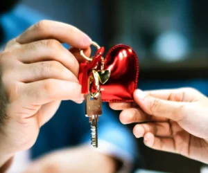 Swinger couple exchanging a set of keys with a heart keychain