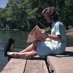 woman reading a playboy adult magazine woman reading a playboy adult magazine