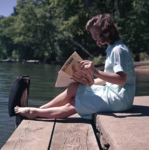 woman reading a playboy adult magazine