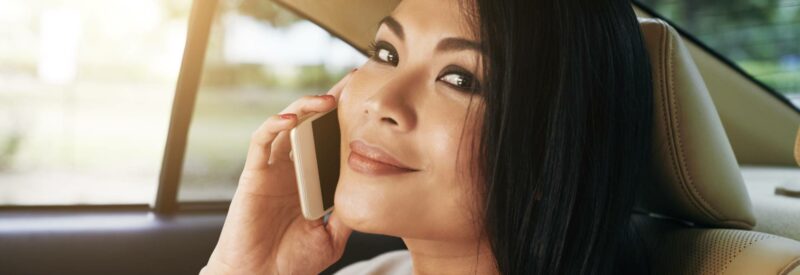 woman on the phone smiling because she's a phone sex operator