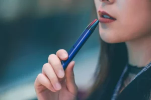 Woman using a vape pen