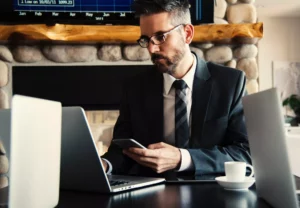 man in a suit making a purchase on his computer