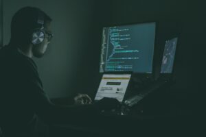 person working on multiple screens person working on multiple screens