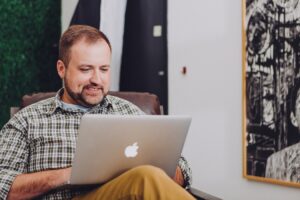 man on laptop processing an electronic check