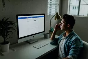Man looking at his accounting breakdown on his computer screen