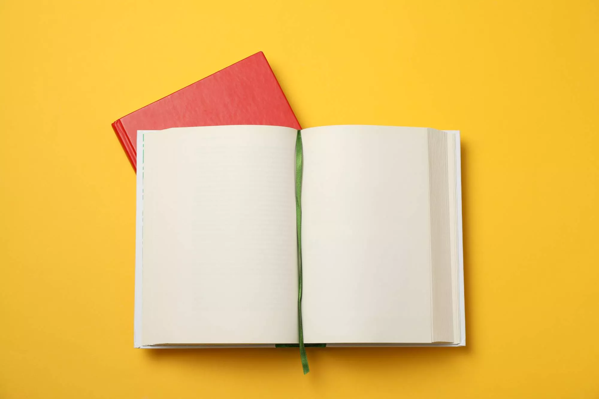 a blank open book on a yellow background ready for a writer to put brand storytelling in it