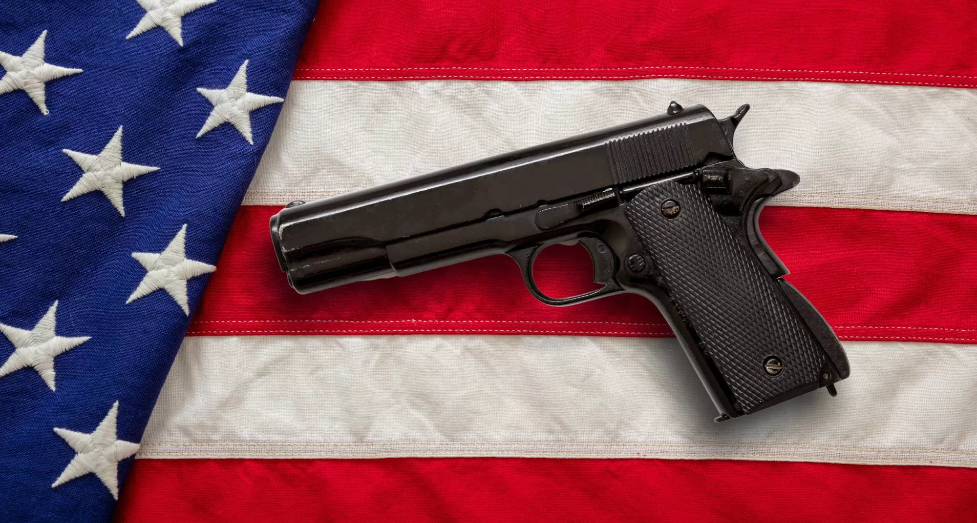 a handgun on United States flag is what someone might picture as they get their FFL license