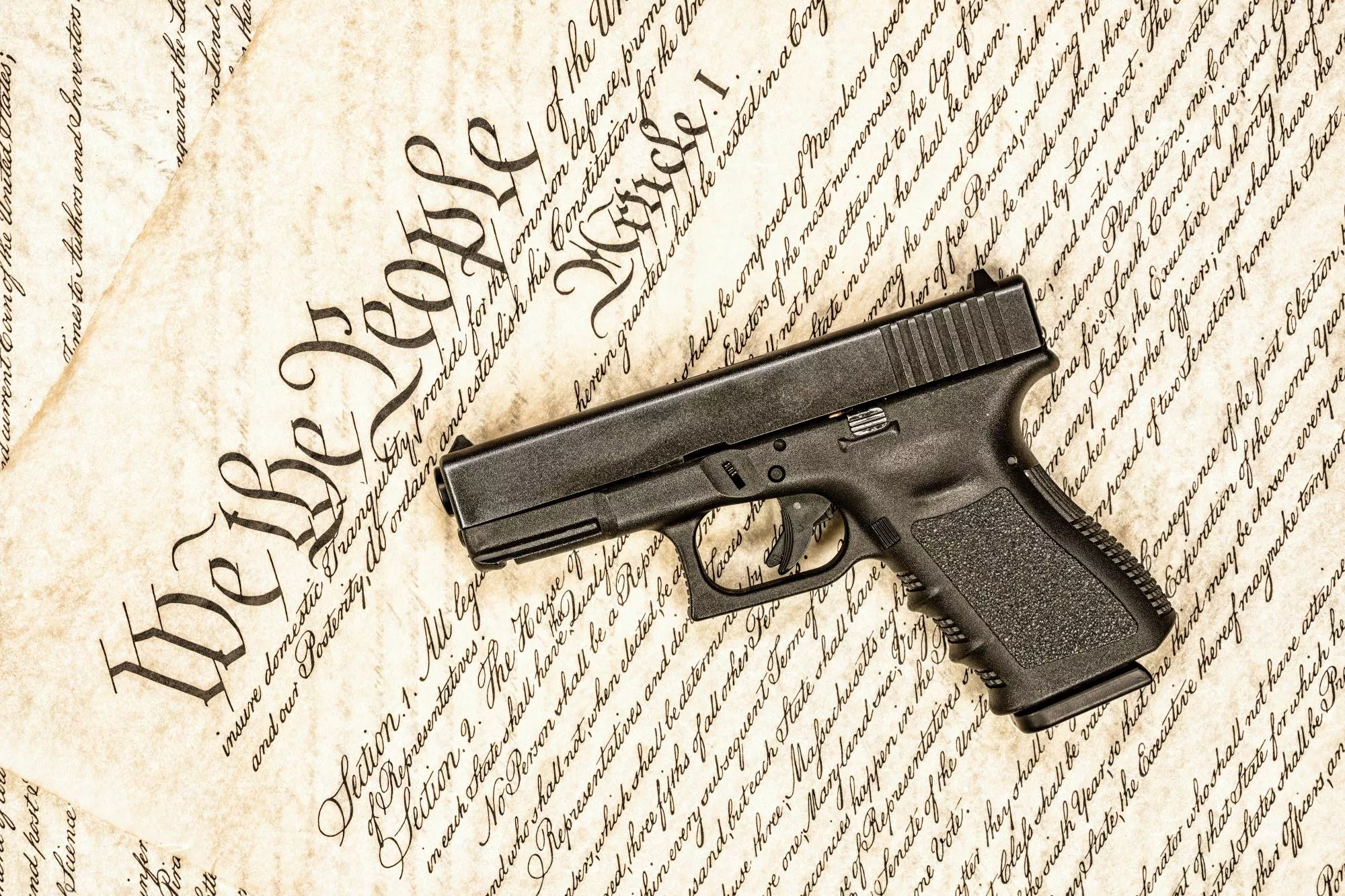 a handgun on United States Constitution that dictates gun laws