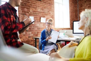 a woman showing the customer churn analysis to her team at the office