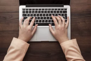 woman typing on laptop researching ach return code R21