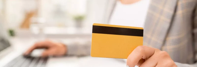 woman holding a credit card for a business line of credit