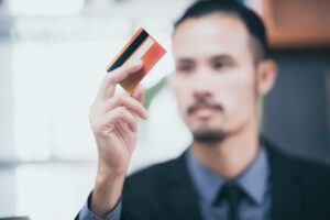 businessman holding a credit card from card issuer