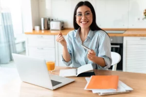 woman at desk smiling and learning about mcc codes