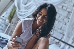 woman looking at phone for phone sexting companies jobs 