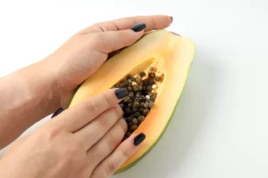 woman's hand touching papaya - sex toy business