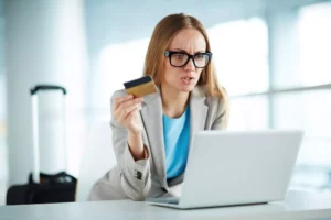 annoyed woman holding a credit card and asking what is an authorization hold