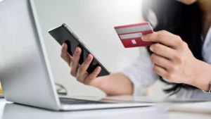 woman with laptop, cell, and credit card  using 3D secure