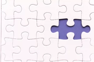 white puzzle with one missing piece showing purple background - ACH Return Code R26