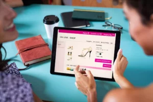 two women shopping for shoes online on tablet abandoning their cart, which triggers an abandoned cart email