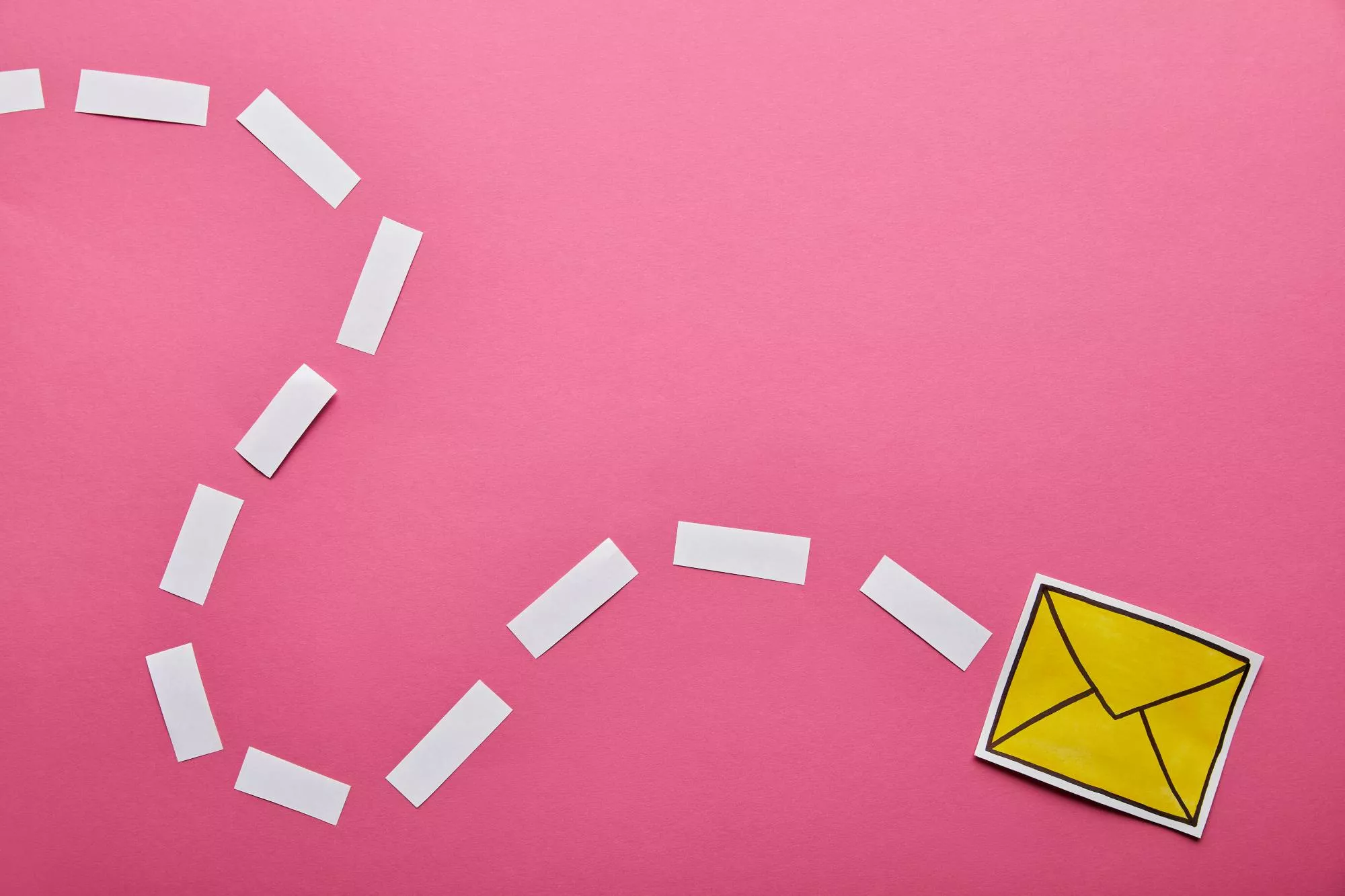 cut out of mail against pink background symbolizing abandoned cart email
