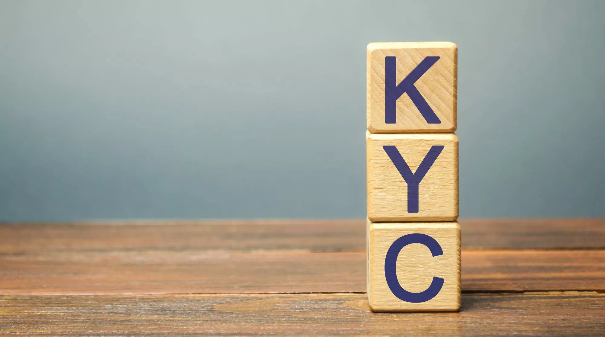 wooden blocks with K, Y, and C on them spelling KYC