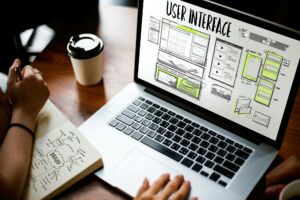 person designing user interface on laptop using best website builder
