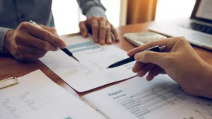 two business people reviewing reports from payment service providers