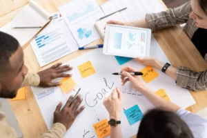 employees hovering over a goal brainstorming session while starting a business