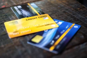 pile of credit cards on wooden table representing FANF fee