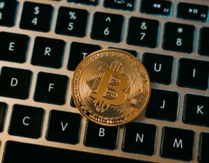 gold bitcoin against laptop keyboard has someone asking what is KYC