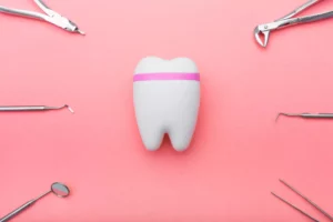 flat lay of tooth and dental tools representing a dental practice deciding between LLC vs PLLC