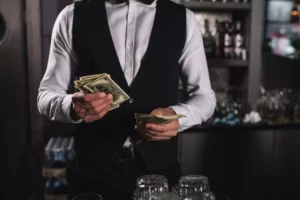 bartender counting their tip payments as a batch processing example