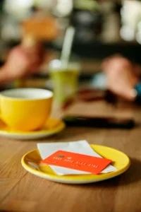 red credit card sitting on table at coffee shop ready for batch processing