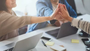 team of workers high fiving because they know how to get an LLC