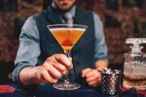 bartender serving a perfect Manhattan cocktail after obtaining a liquor license