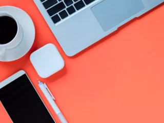 flat lay of modern workspace with a laptop and coffee at a business with a merchant id number