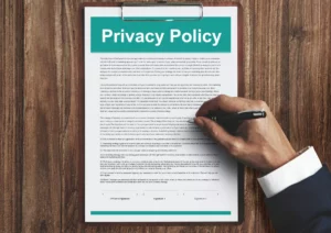 man in a suit signing a privacy policy on wood table