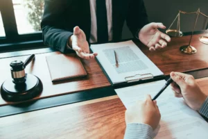 lawyer pondering a professional LLC vs LLC while sitting at a desk and reviewing documents with a client 