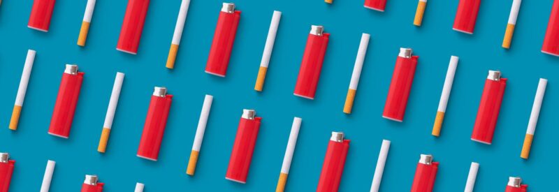 cigarettes and red lighters on blue background that you can sell if you have a tobacco license