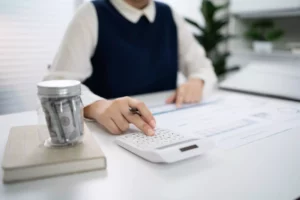 A business owner sitting at their desk with a form and calculator to create a quote