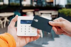 business owner accepting contactless credit card payment with clover pos system