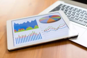 a digital tablet showing graphs from an accounting software showing how to keep track of business expenses