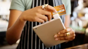 A business owner swiping a card on a square magstripe.