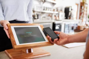 contactless payment made with phone at POS station that you might consider when debating square vs clover