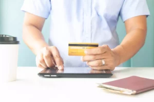 man putting credit card information into tablet but stripe holding funds from merchant