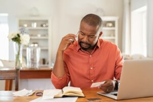 person tapping their phone to a mobile reader Man looking puzzled after receiving an ACH return code