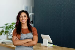 Female business owner smiling after being approved for a minority business grant 