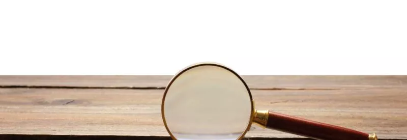 a magnifying glass on a table to symbolize business tax ID
