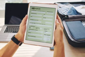 man holding tablet showing a form for an electronic check