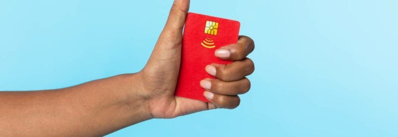 someone holding a thumbs up with a credit card in their hand to represent facebook pay